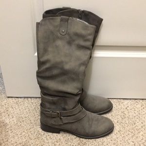 Gray riding boots.